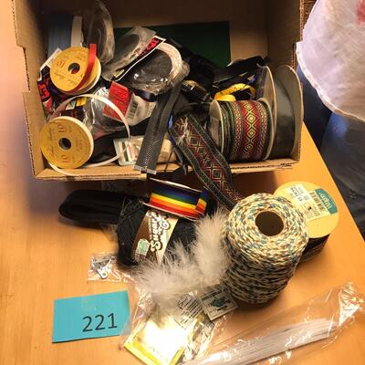 Flat of ribbon and sewing items.