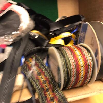 Flat of ribbon and sewing items.