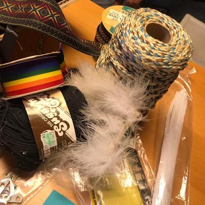 Flat of ribbon and sewing items.
