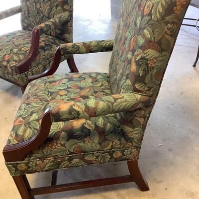 2 upholstered arm chairs with wooden legs and arms with slip covers