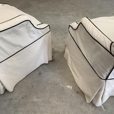 2 upholstered arm chairs with wooden legs and arms with slip covers