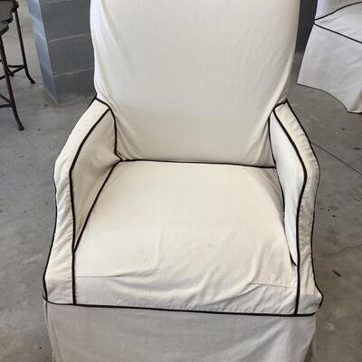 2 upholstered arm chairs with wooden legs and arms with slip covers
