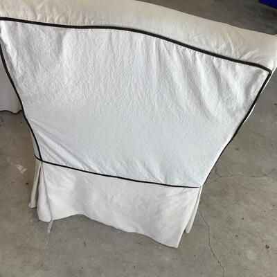 2 upholstered arm chairs with wooden legs and arms with slip covers