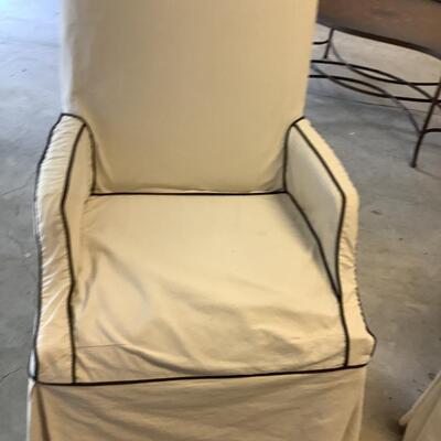 2 upholstered arm chairs with wooden legs and arms with slip covers