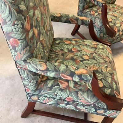 2 upholstered arm chairs with wooden legs and arms with slip covers