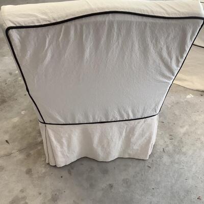 2 upholstered arm chairs with wooden legs and arms with slip covers