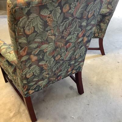 2 upholstered arm chairs with wooden legs and arms with slip covers