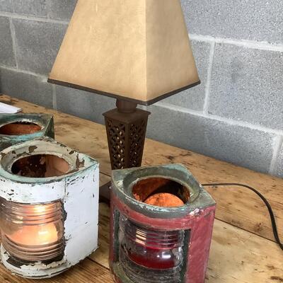 Vintage Bow & stern running lights shown with candles and a lamp