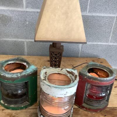Vintage Bow & stern running lights shown with candles and a lamp