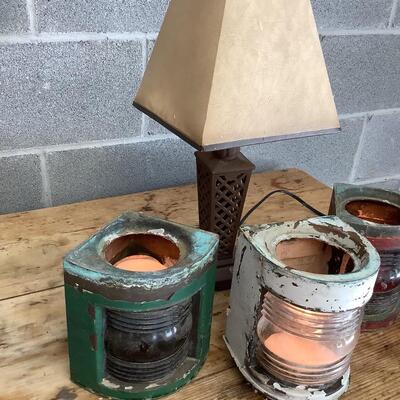 Vintage Bow & stern running lights shown with candles and a lamp