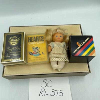 Rubikâ€™s cube, doll, farmerâ€™s state bank cards