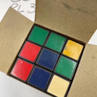 Rubikâ€™s cube, doll, farmerâ€™s state bank cards