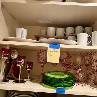 wine goblets with red swirls, green plates set white dinner plates and mugs