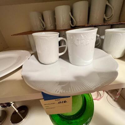 wine goblets with red swirls, green plates set white dinner plates and mugs