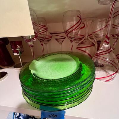 wine goblets with red swirls, green plates set white dinner plates and mugs