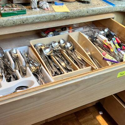 large flatware drawer full of knives, forks, spoons and servers