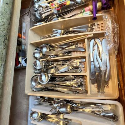 large flatware drawer full of knives, forks, spoons and servers