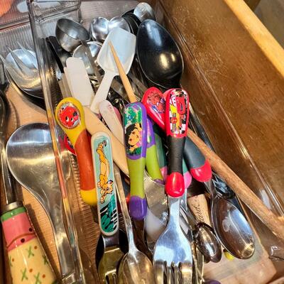 large flatware drawer full of knives, forks, spoons and servers