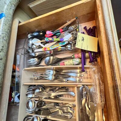 large flatware drawer full of knives, forks, spoons and servers