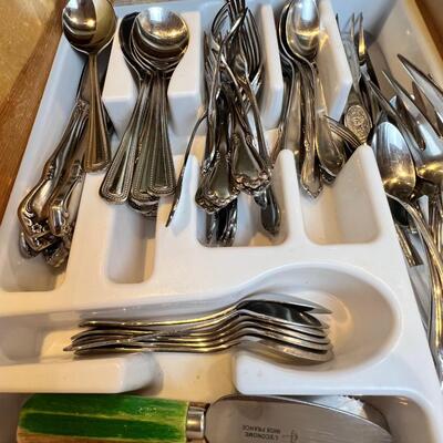 large flatware drawer full of knives, forks, spoons and servers
