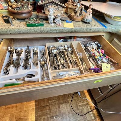 large flatware drawer full of knives, forks, spoons and servers