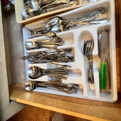large flatware drawer full of knives, forks, spoons and servers