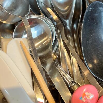 large flatware drawer full of knives, forks, spoons and servers