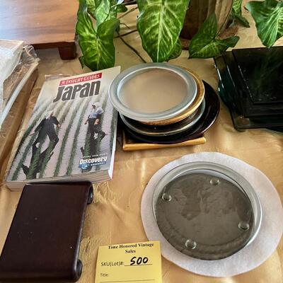 magazine holder with Art books, artificial plants, displays,  and stands