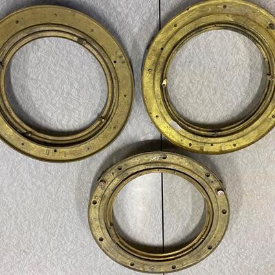 Three brass port holes, no glass