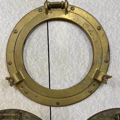 Three brass port holes, no glass