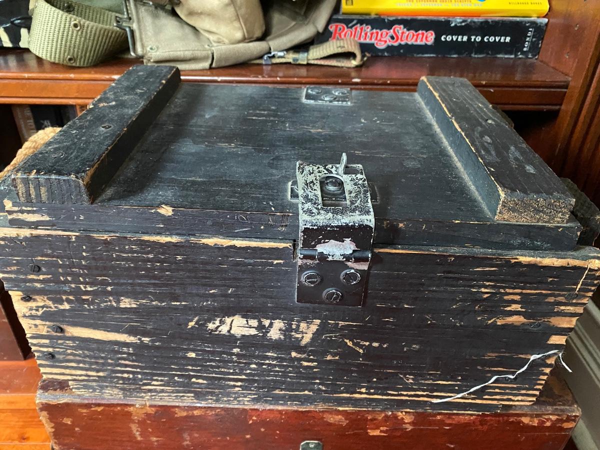 Old wooden ammo box with rope handles, lockable clasp