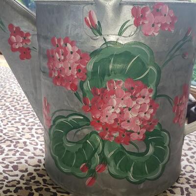 2 pots, a watering can and a topiary