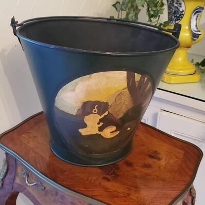 Painted bucket of dog with shells in it