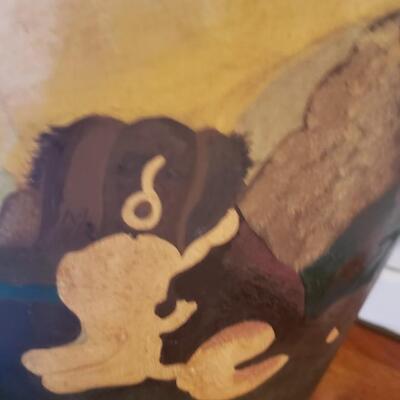 Painted bucket of dog with shells in it