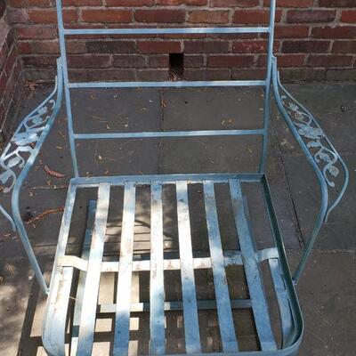 Two wrought iron chairs, footstool and table