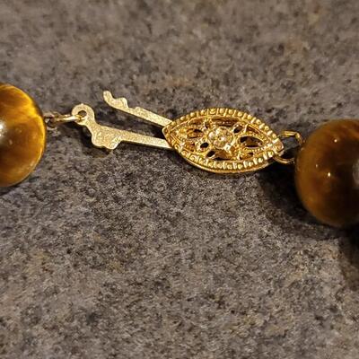 Lot 103: Tiger's Eye Necklaces - (1) with a 14k Gold Clasp