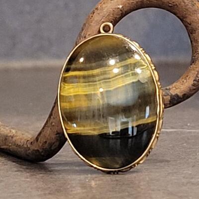 Lot 129: Large Tiger's Eye Gold Plated Pendant