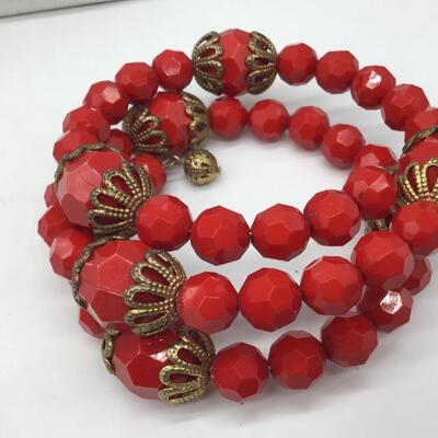Red Faceted Plastic Type wrap Bracelet. Gold Accent