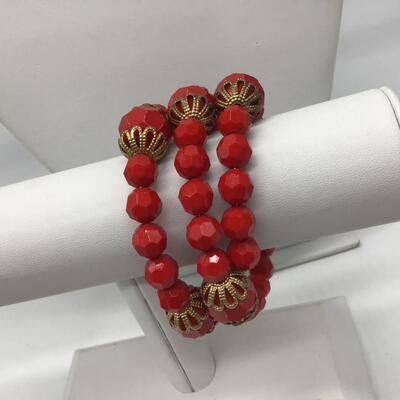 Red Faceted Plastic Type wrap Bracelet. Gold Accent