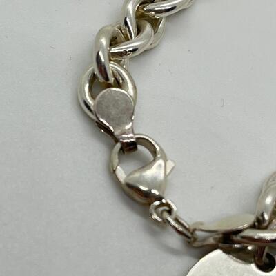 LOT 26: Sterling Silver Charm Bracelet - 30.1 Grams total weight