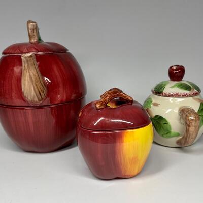 Lot of three apple themed tea pot and sugar bowls