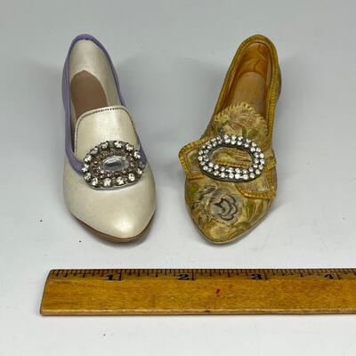 Pair of miniature white purple and gold shoe figurines
