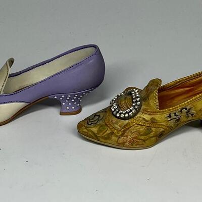 Pair of miniature white purple and gold shoe figurines