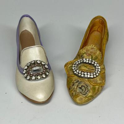 Pair of miniature white purple and gold shoe figurines