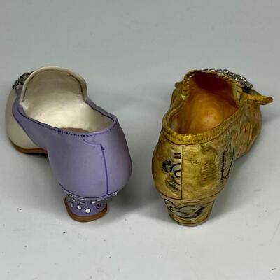Pair of miniature white purple and gold shoe figurines