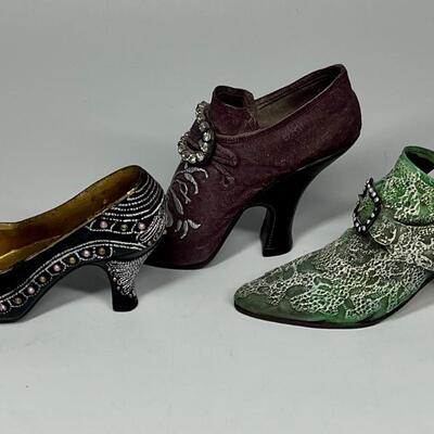 Lot of three miniature purple green and blue shoe figurines