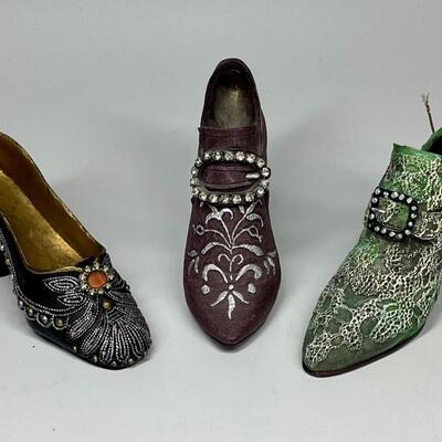 Lot of three miniature purple green and blue shoe figurines