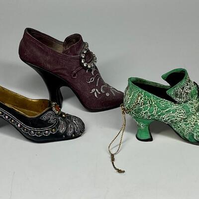 Lot of three miniature purple green and blue shoe figurines