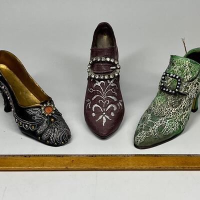 Lot of three miniature purple green and blue shoe figurines