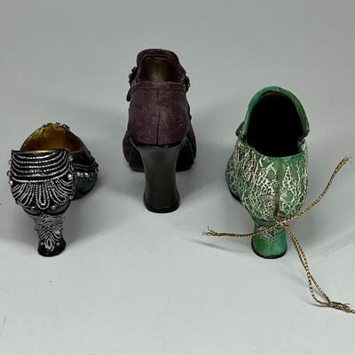 Lot of three miniature purple green and blue shoe figurines